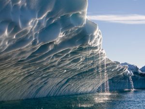 31 Jul 2006, Ilulissat, Greenland --- Melting water streams from iceberg calved from Ilulissat Kangerlua Glacier (Jakobshavn Icefjord) in Disko Bay. --- Image by © Paul Souders/Corbis